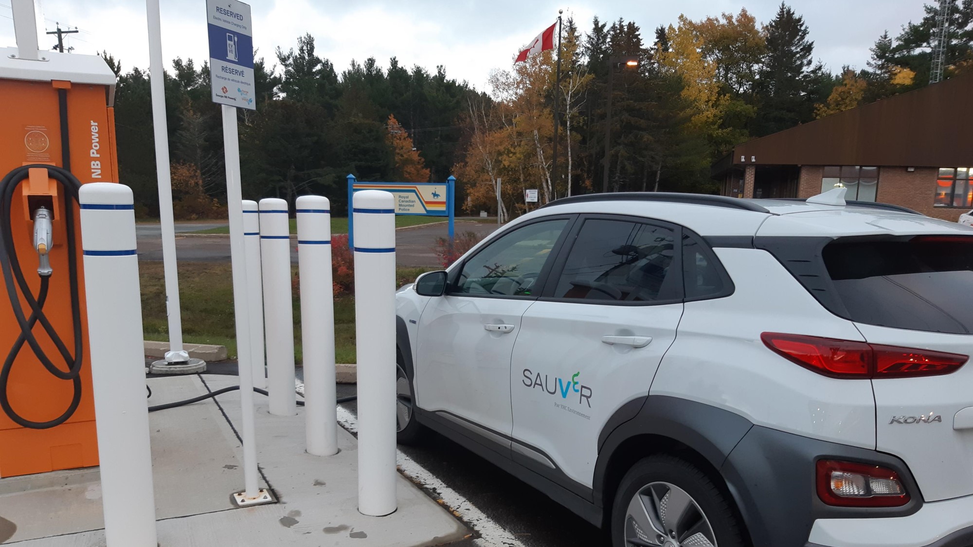 Car using electric charging station. 