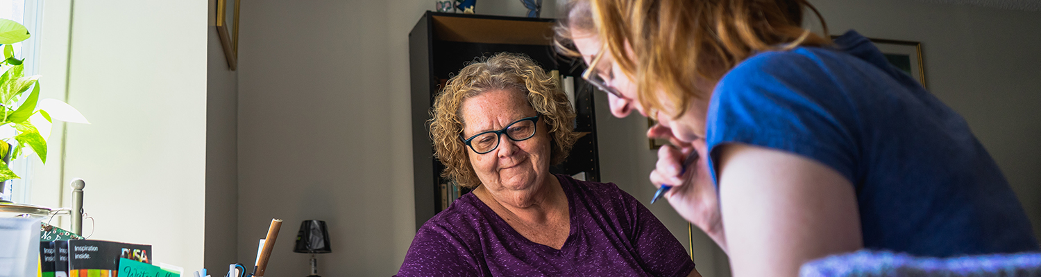 A member of The Atmospheric Fund consults with a resident in her home