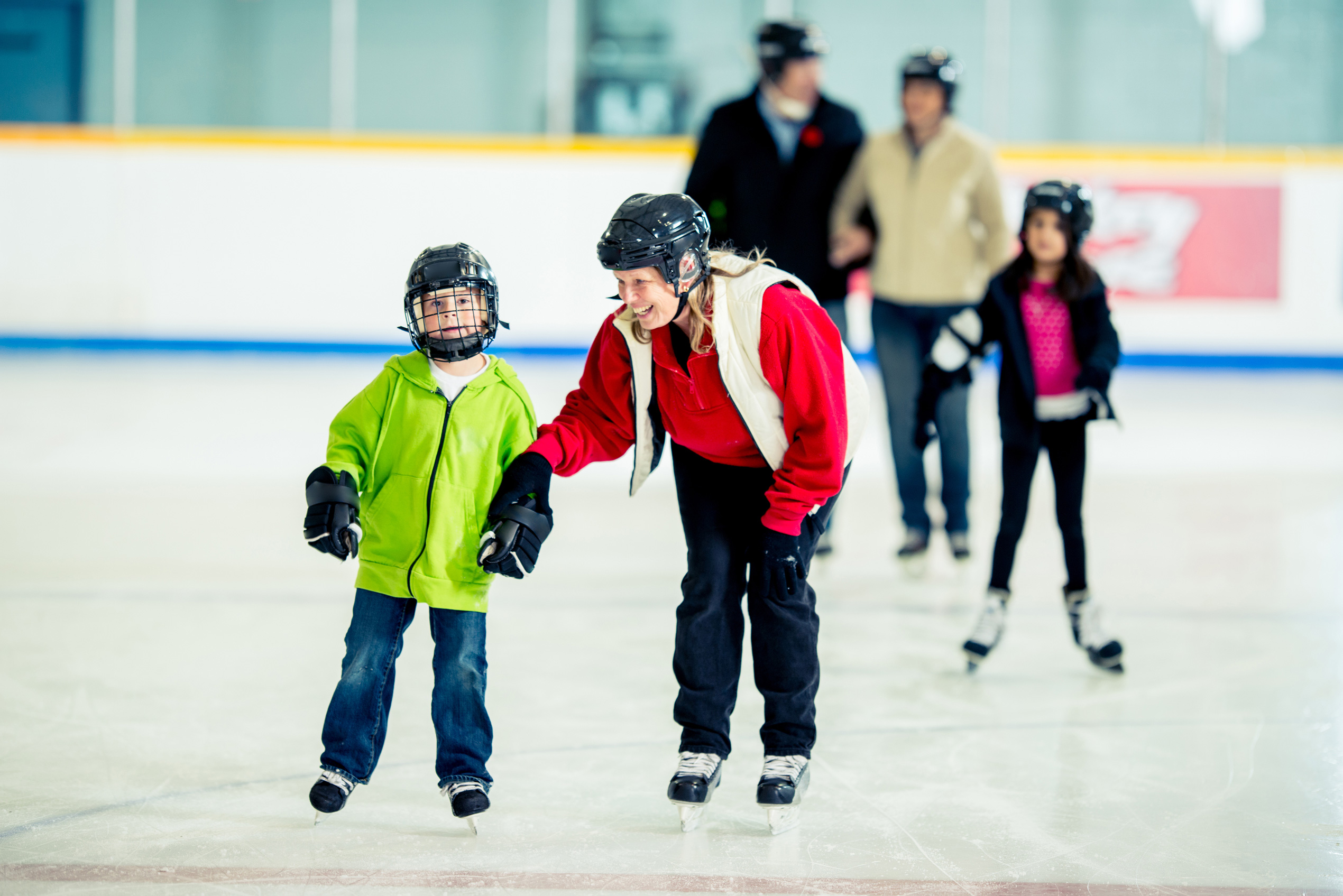 Family skating at an ice rink