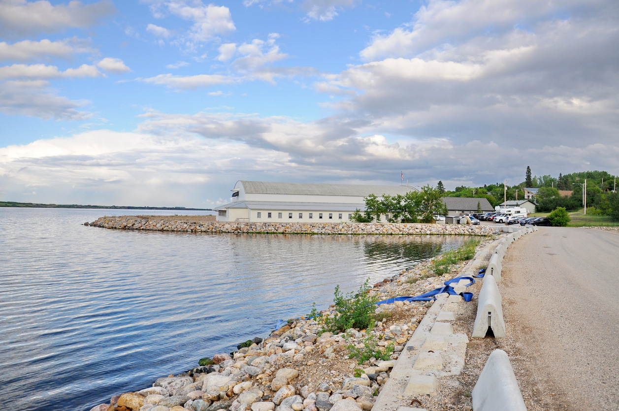 View of a white building built near a large lake.