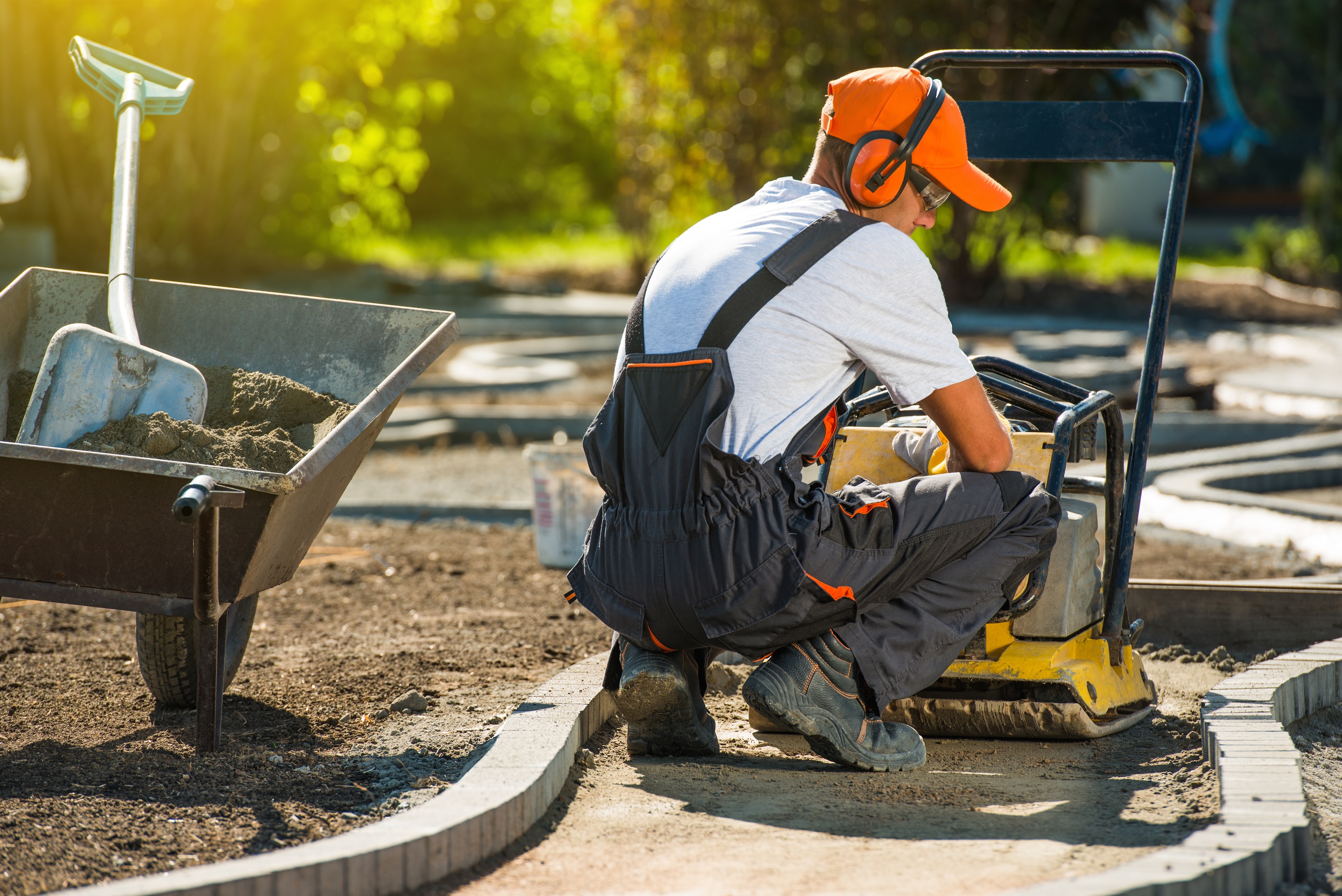 Man in hard hat inspects road work.