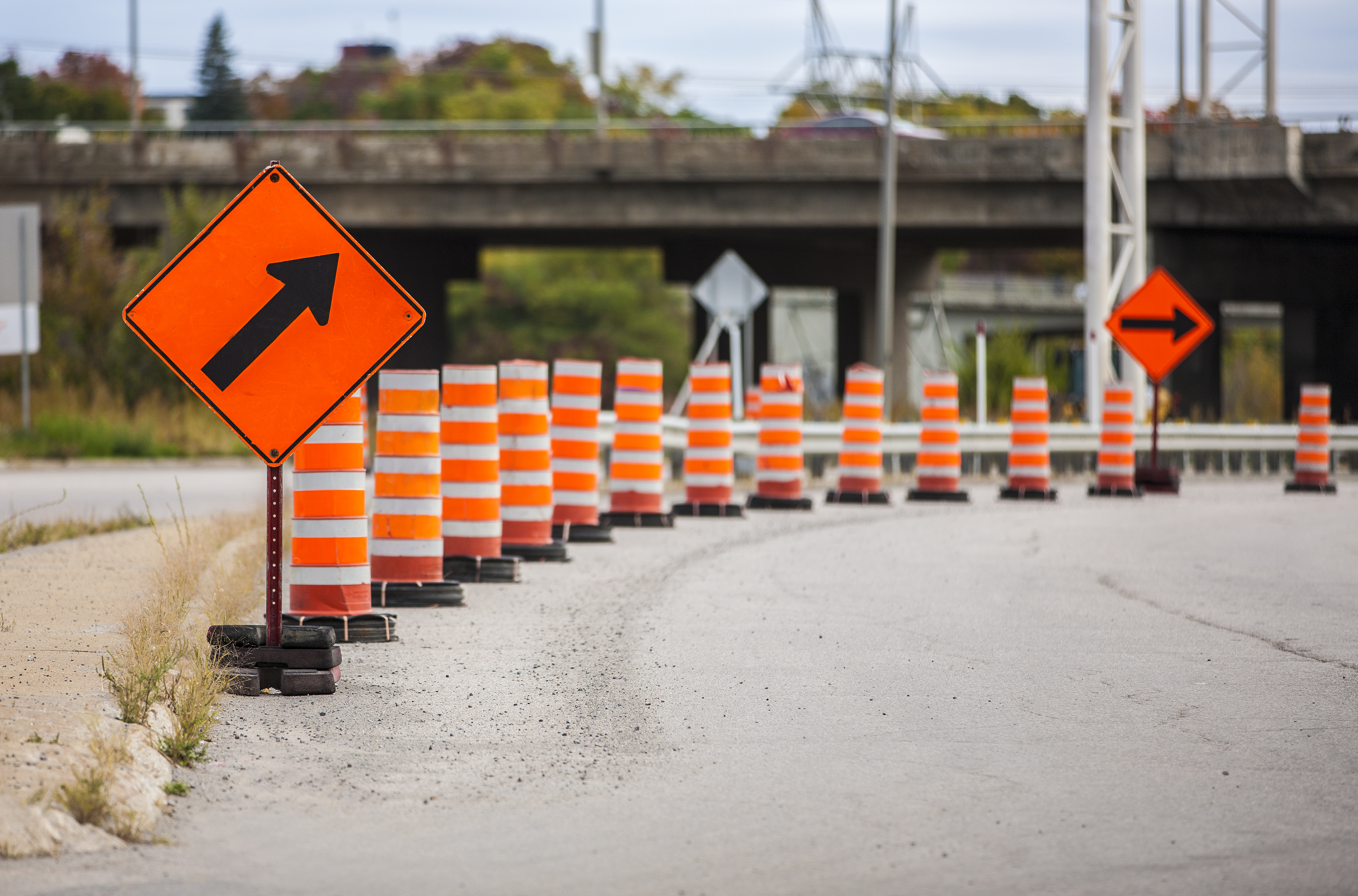 Line of orange traffic cones on a road.  