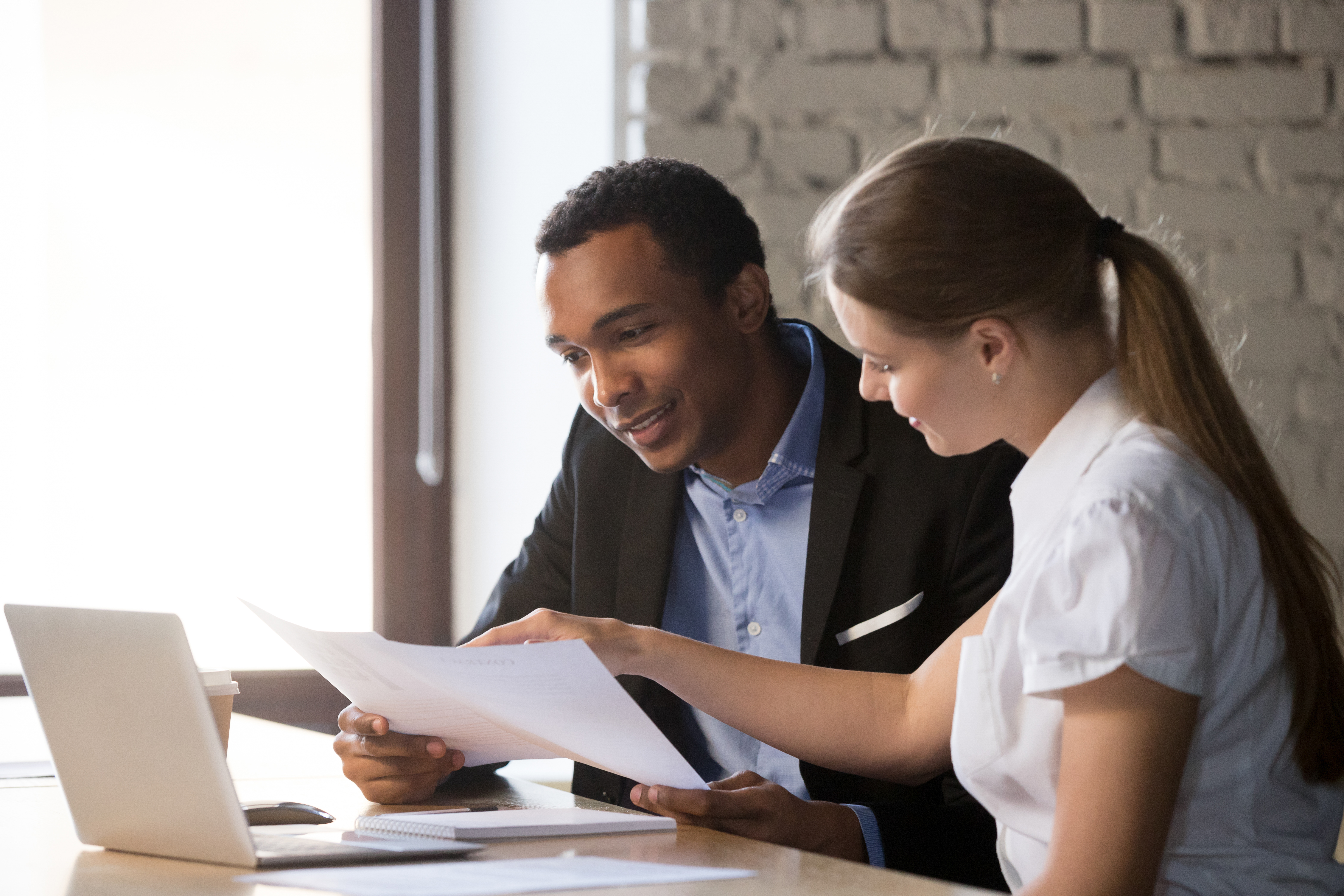 Woman and man working together in front of a computer.