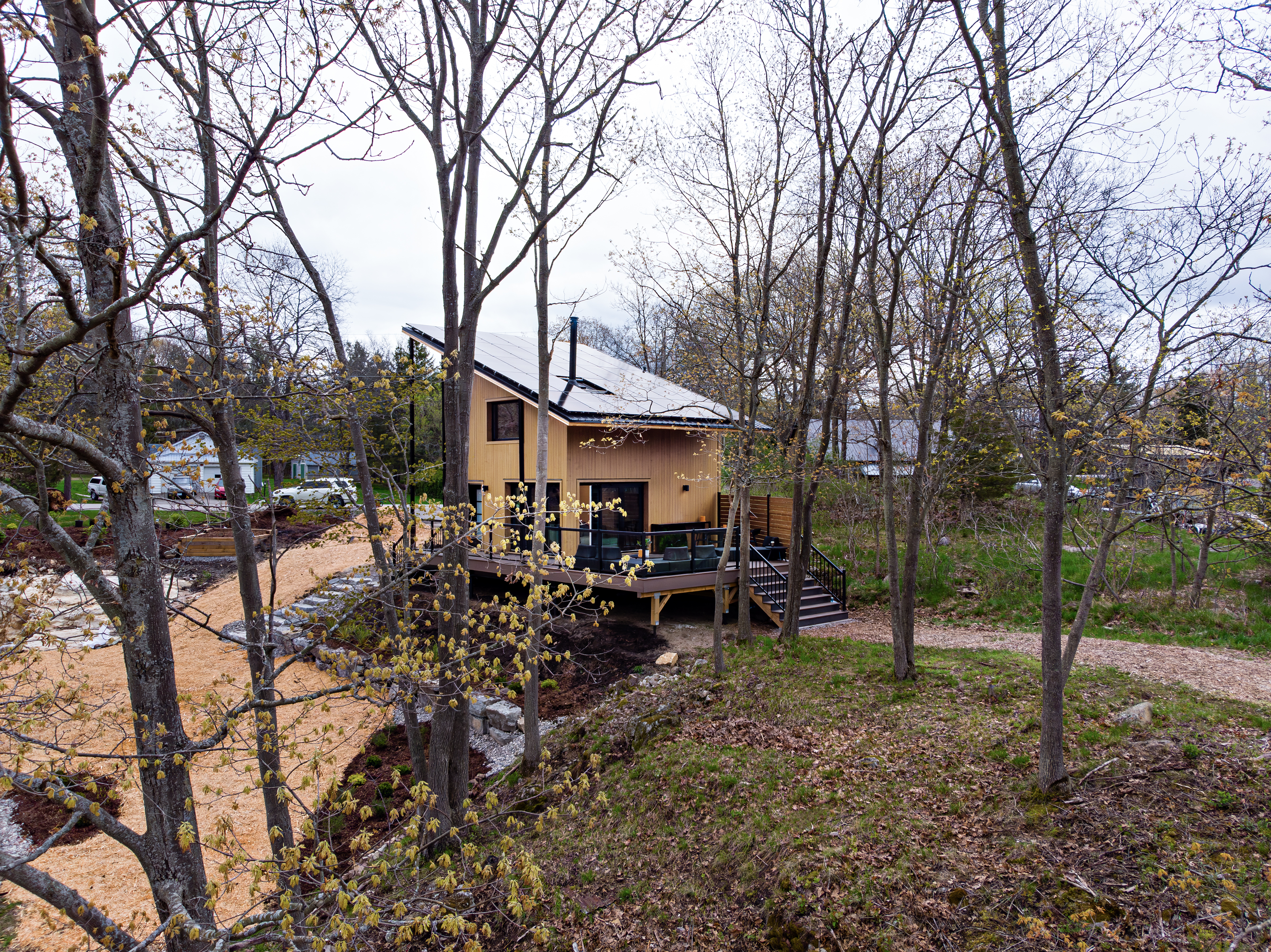 A completed CABN home on a large lot surrounded by trees