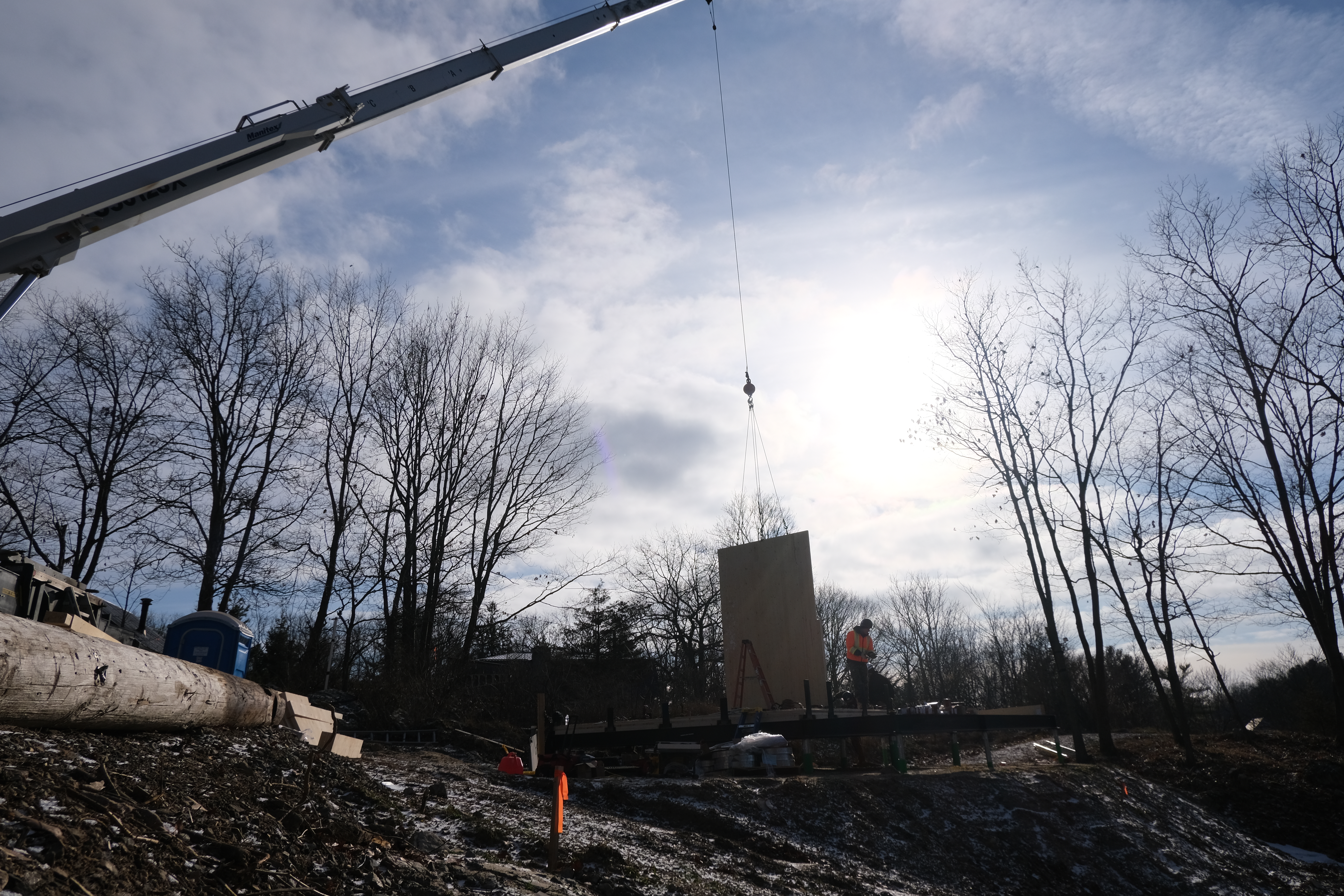 A crane works on a CABN home under construction