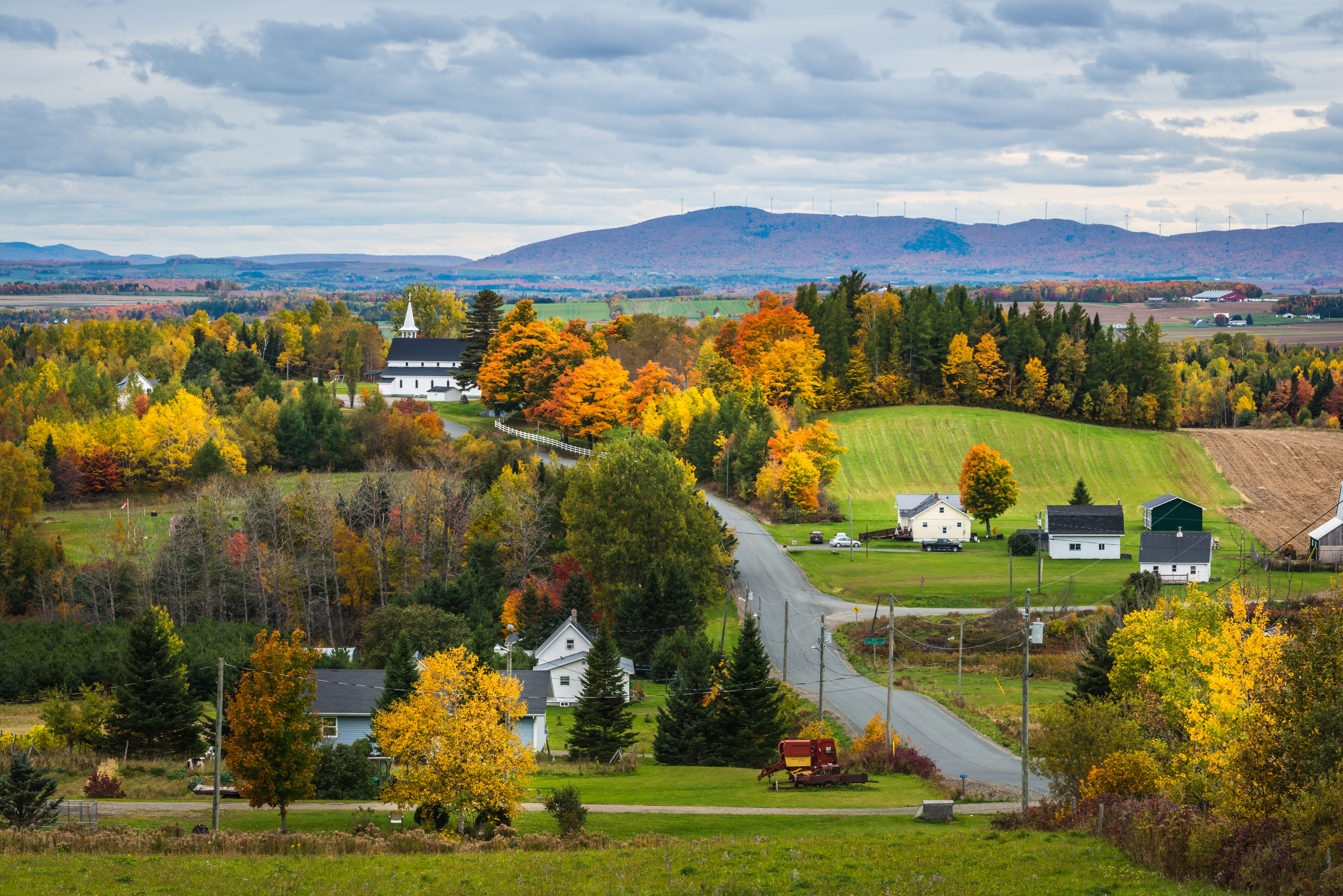 A quiet Canadian small town surrounded by trees with fall colours. 