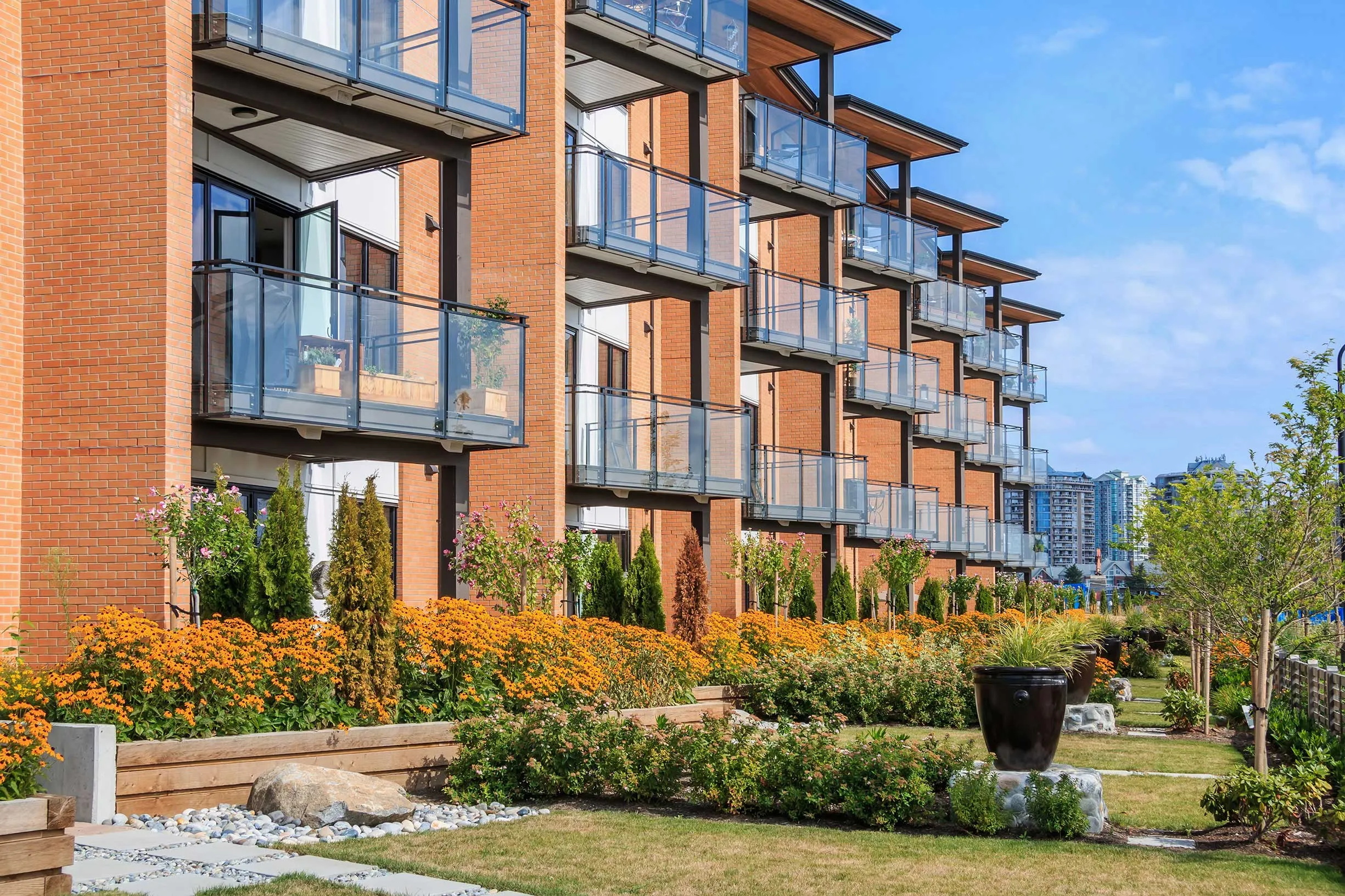 New apartment buildings made of red brick and glass balconies. 