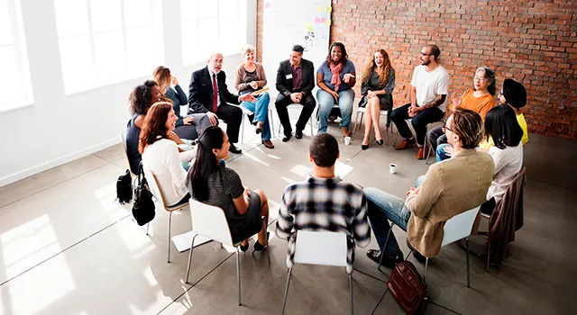 Group of people at work sitting in circle