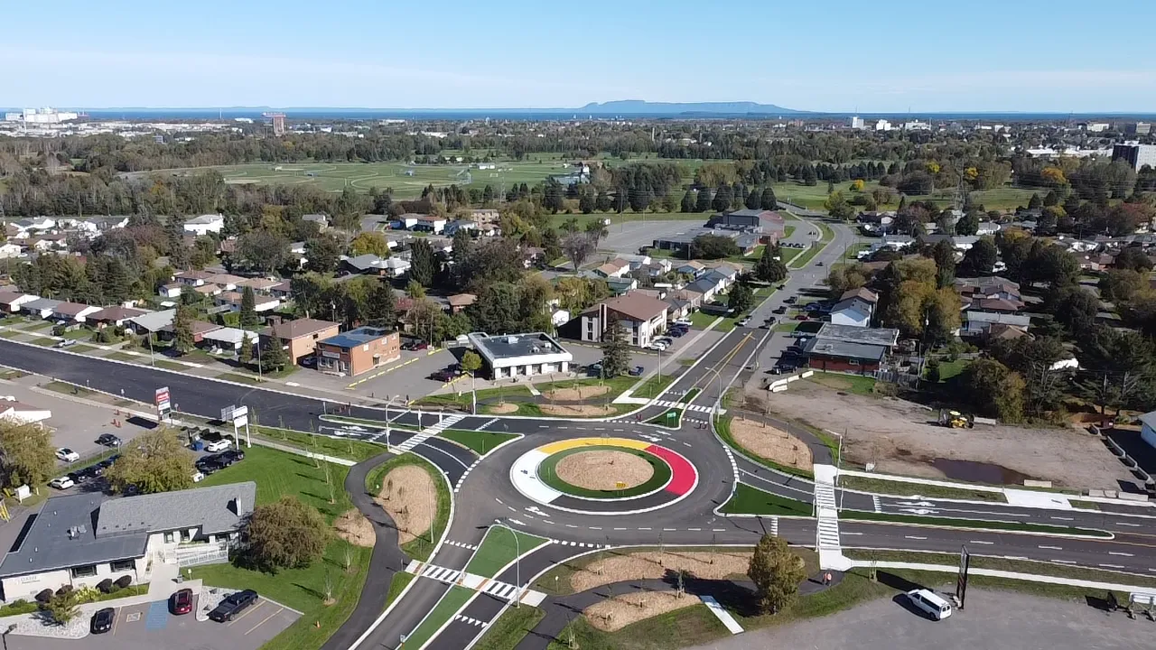 A large four-way roundabout with The Sleeping Giant in the background.