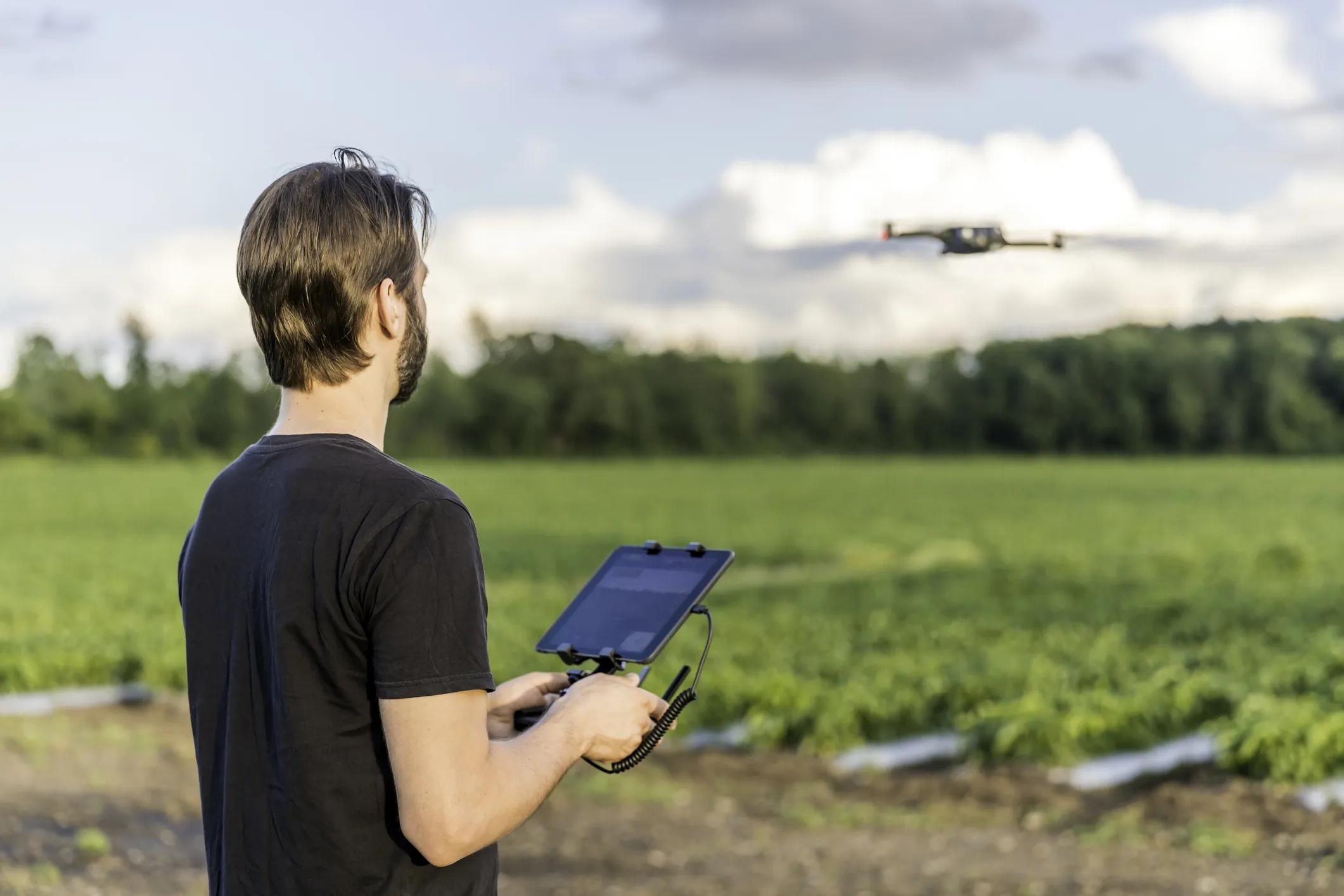 Man using a drone to map canopy cover in his community.