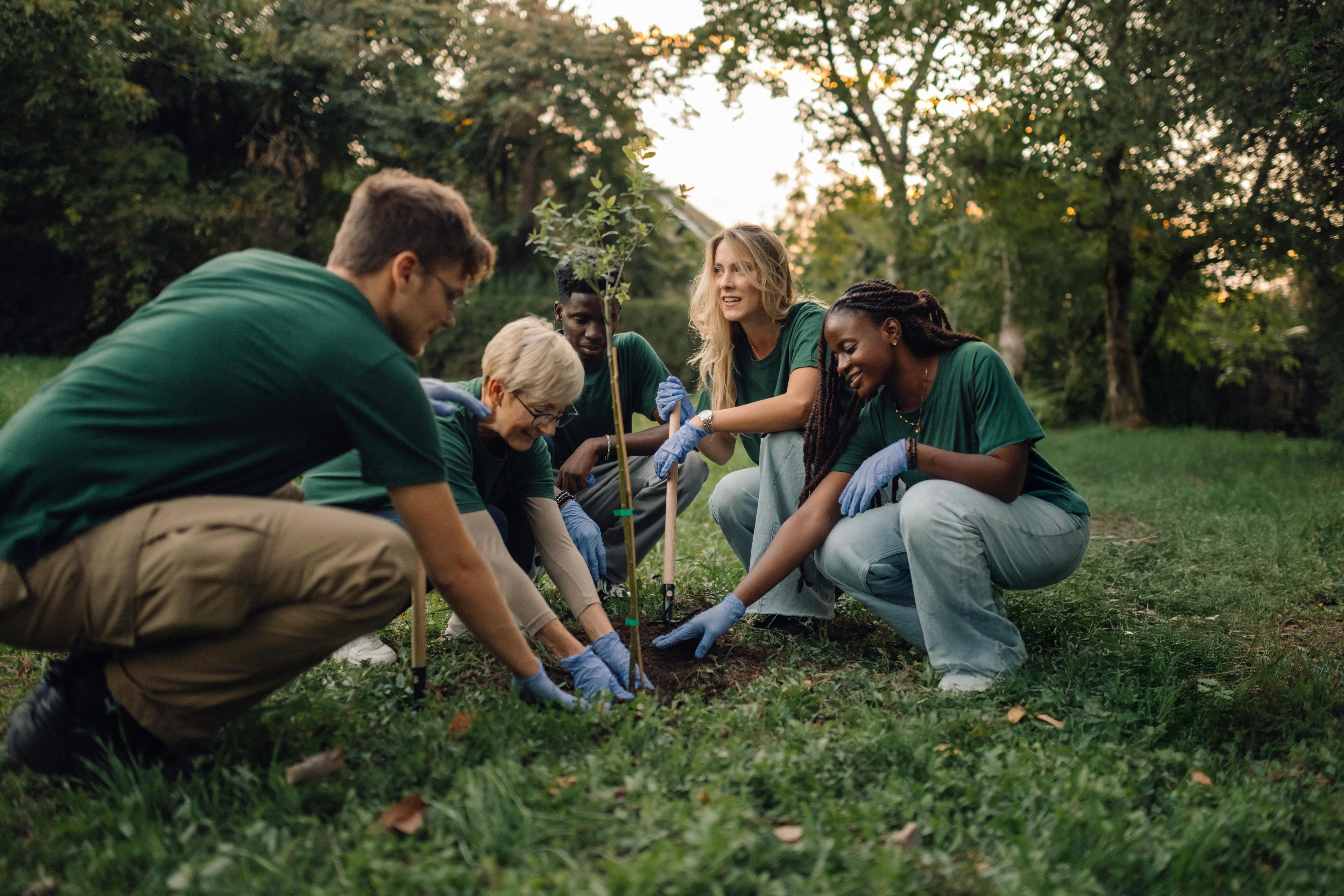Community members planting a tree.