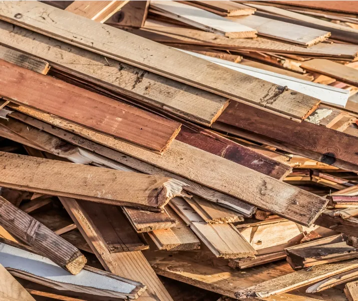Heap of old cracked rotten scrapped pine wood decking planks