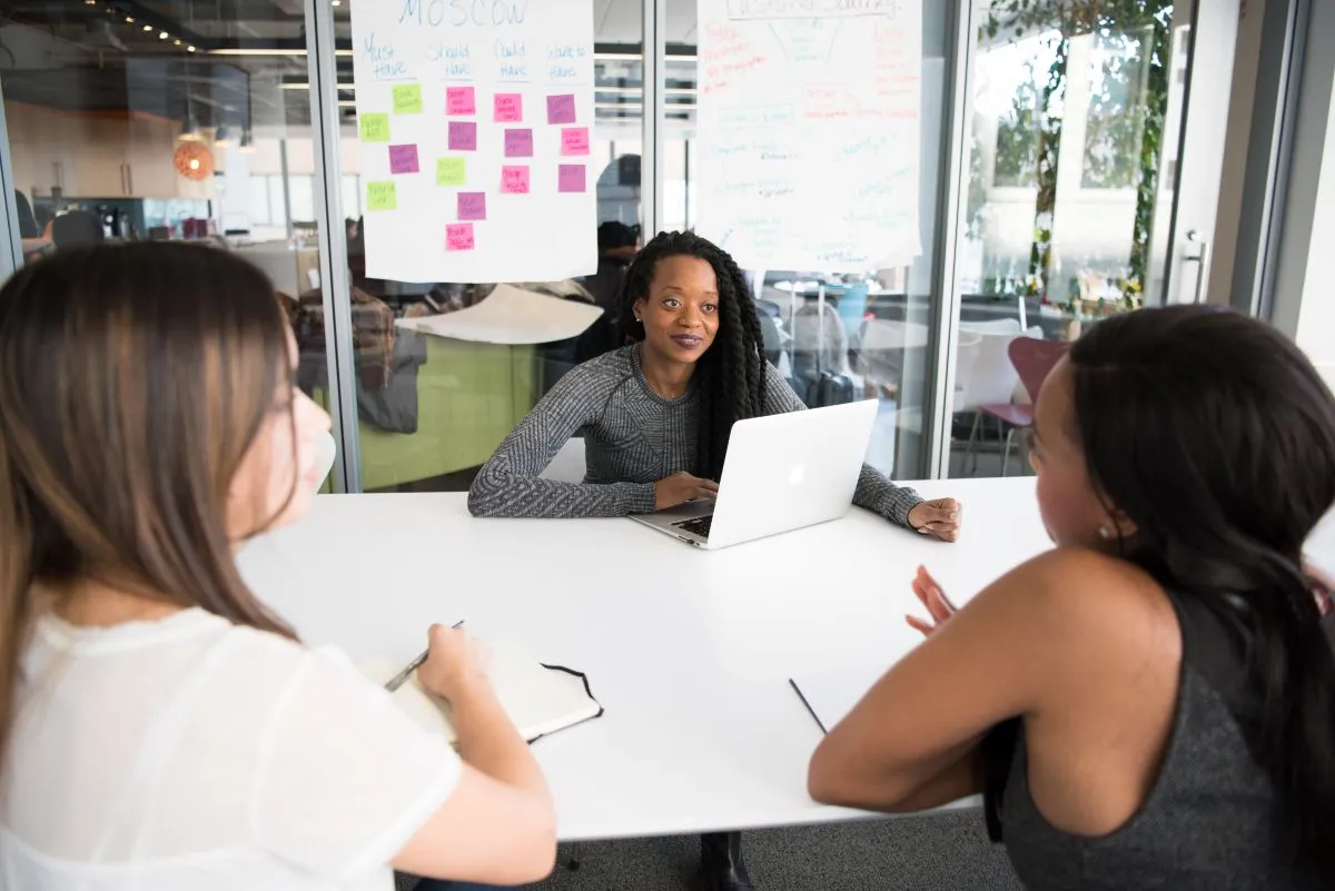 women in boardroom, discussing project.