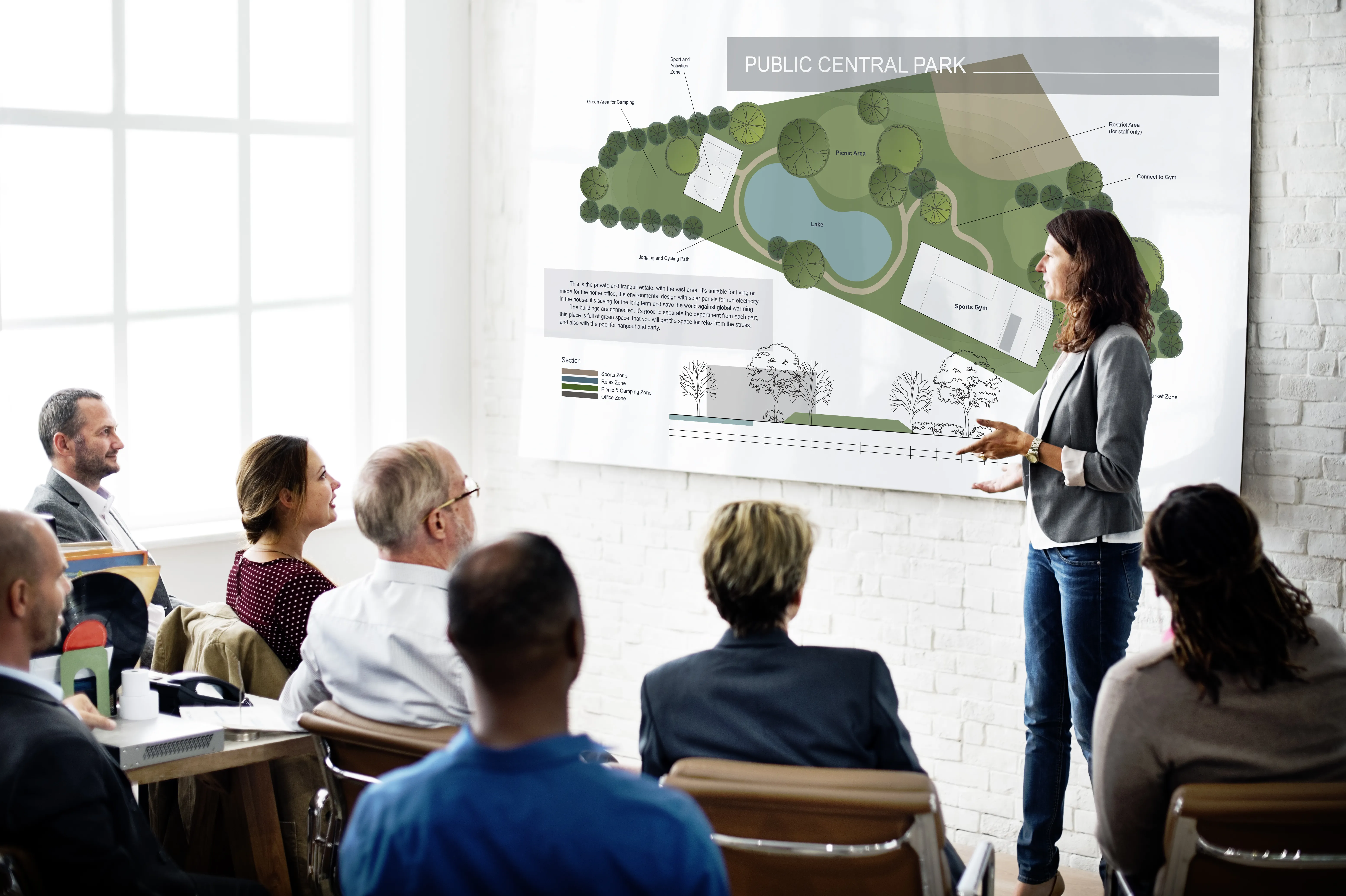 A city official is presenting the value of a new urban forest to a group of very attentive people